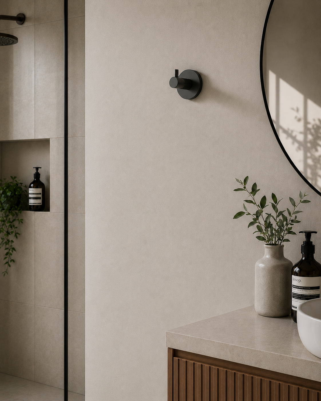 Bathroom interior with a round mirror, countertop, and wall-mounted fixtures.