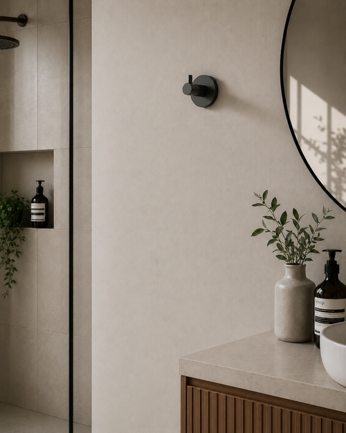 Bathroom interior with a round mirror, countertop, and wall-mounted fixtures.