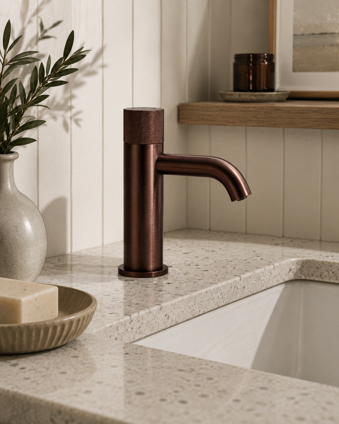 Bronze faucet on a bathroom counter with a neutral background