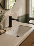 Bathroom sink with black faucet and beige countertop