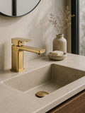 Bathroom sink with gold faucet and decorative elements